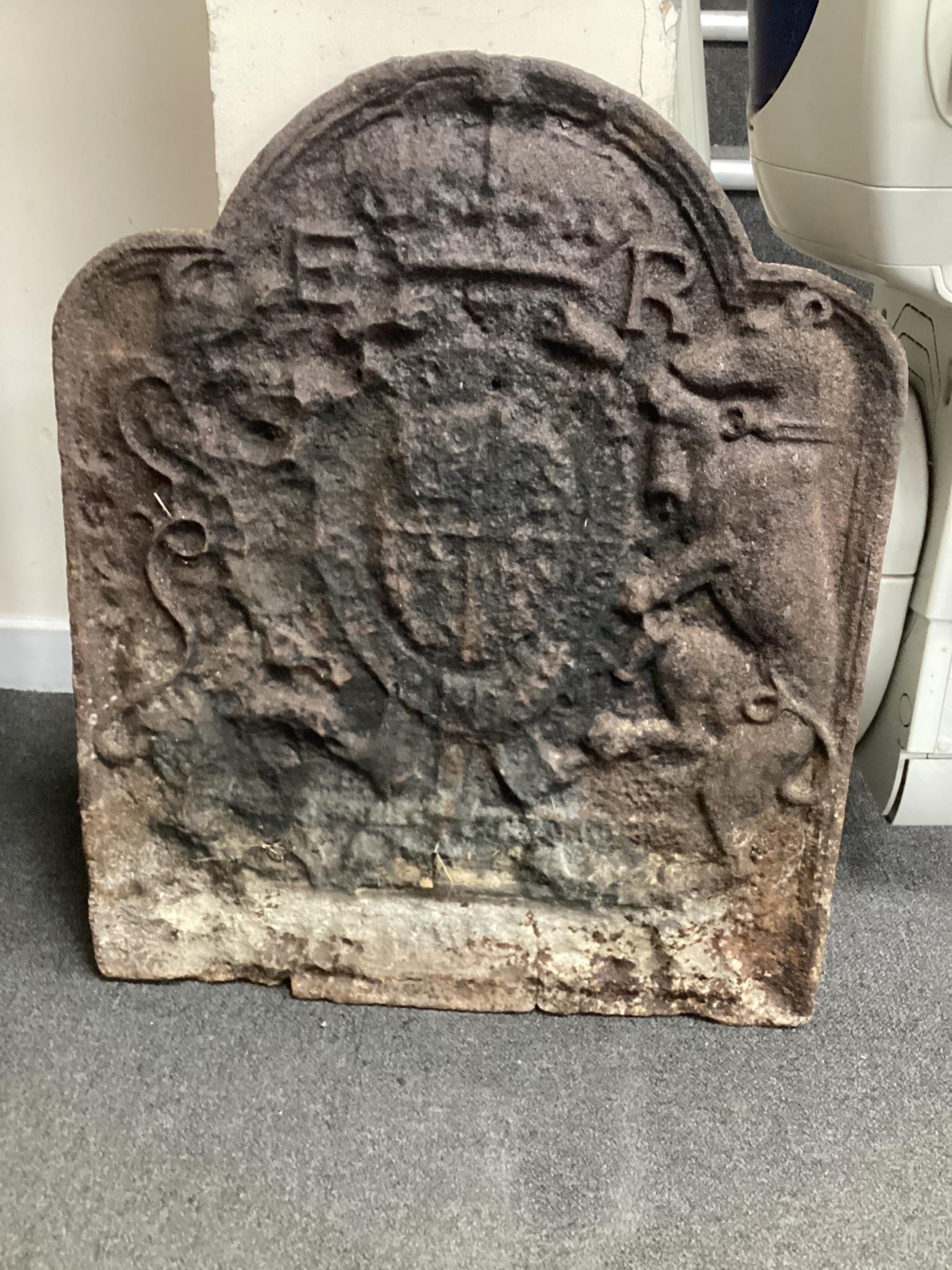 A Tudor cast iron fire back, believed to be Edward VI coat of arms and cast by John Harvo, width 62cm height 75cm.